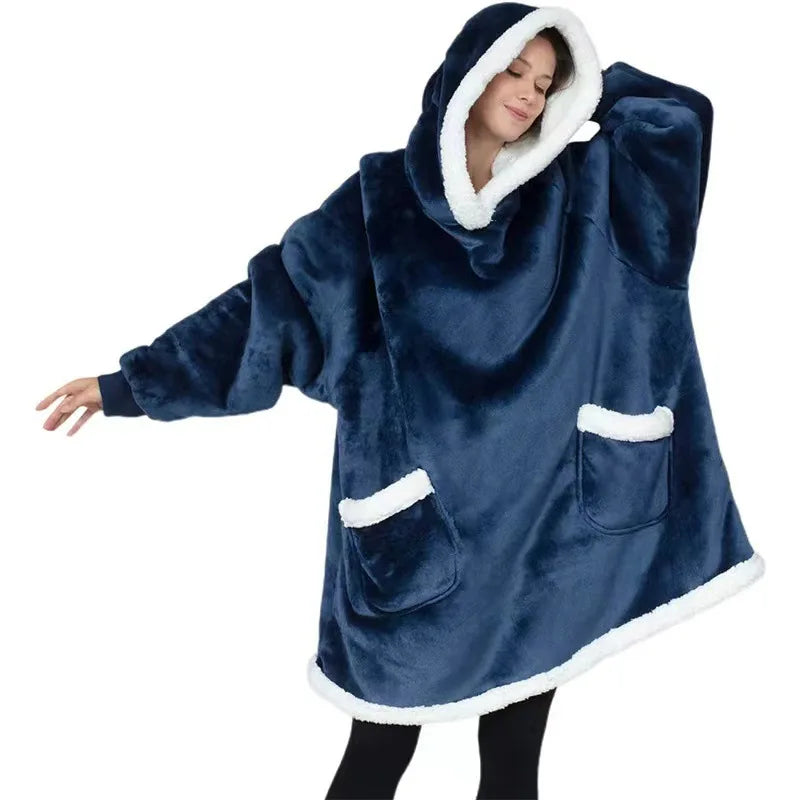 Woman wearing a navy thick oversized hoodie on a white background.