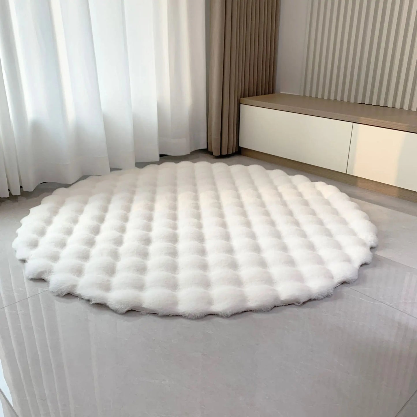 White round bubble velvet plush rug shown on a light tiled floor in a bright room