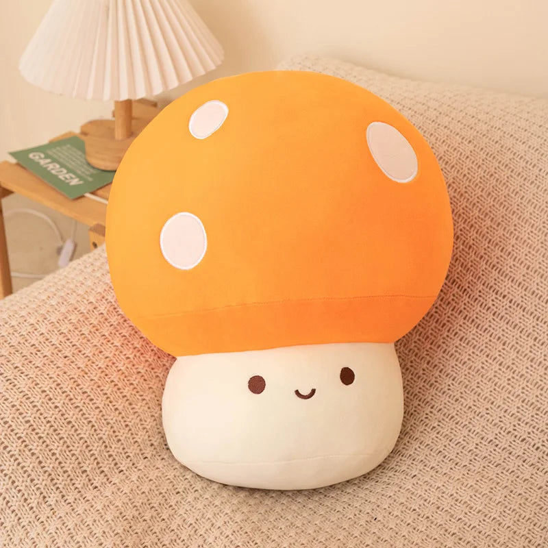 Orange soft plush mushroom toy on a soft surface.