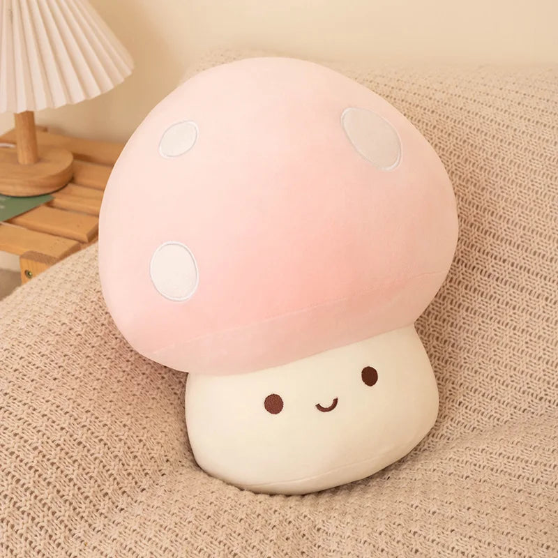 Pink soft plush mushroom toy on a soft surface.