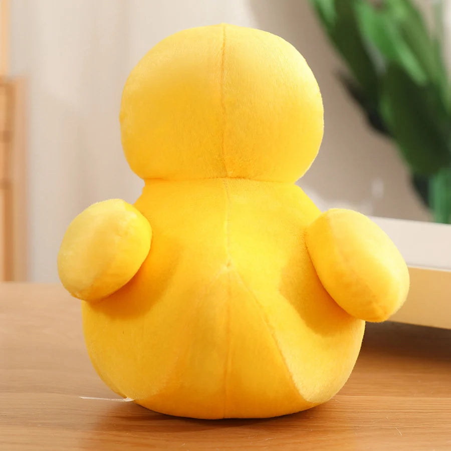 Yellow duck plush toy shown from the back, featuring a rounded shape and small wings