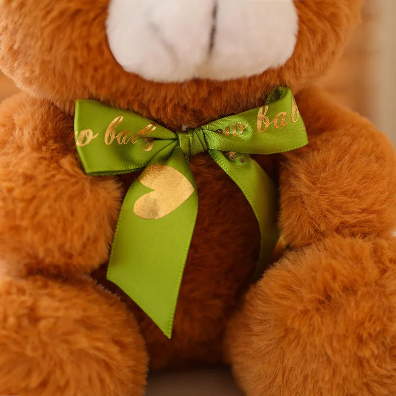 Close up of a bow tie on a soft plush brown bear toy.