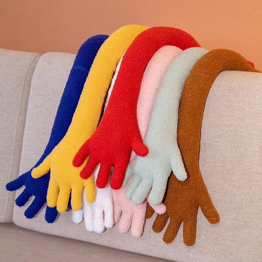 Colourful plush simulation hands draped over a couch.