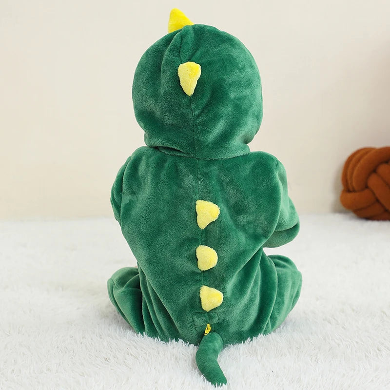 Green dinosaur costume with yellow spikes on a white surface