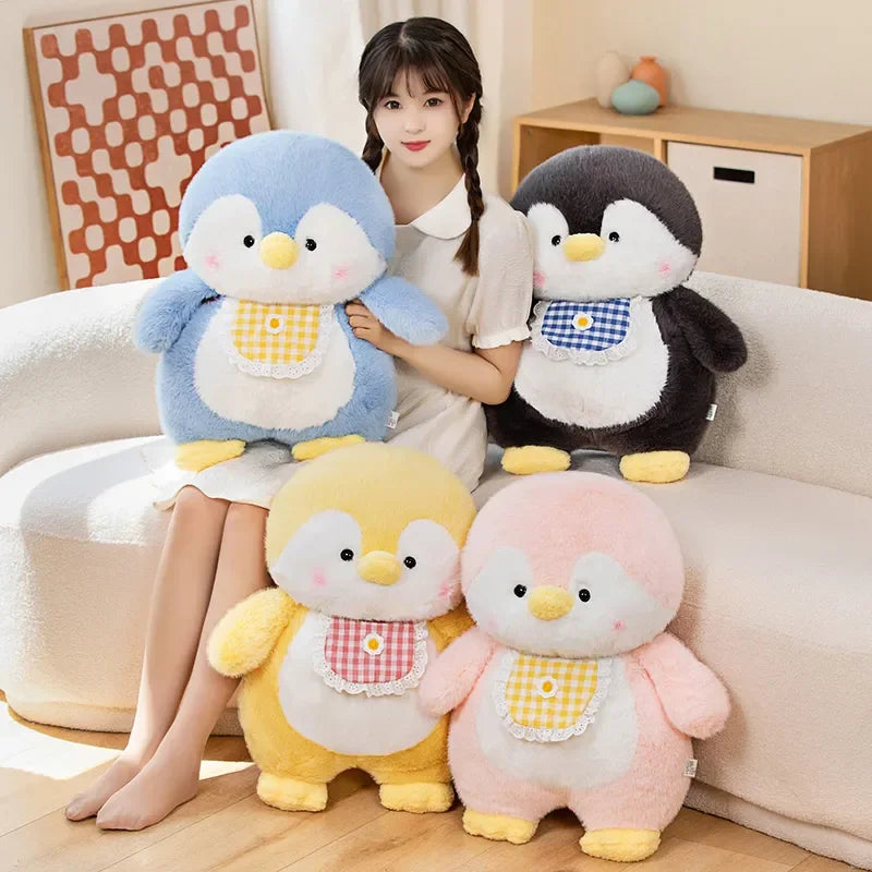 Woman holding four colorful penguin plush toys in a living room setting.