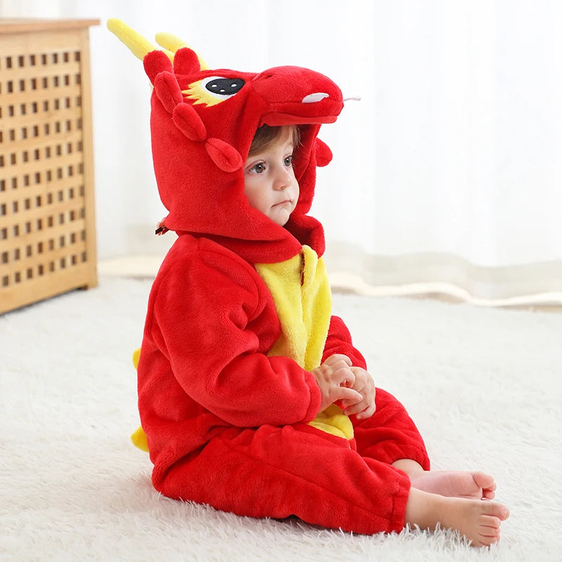 Child wearing a red dragon costume sitting on a white surface.