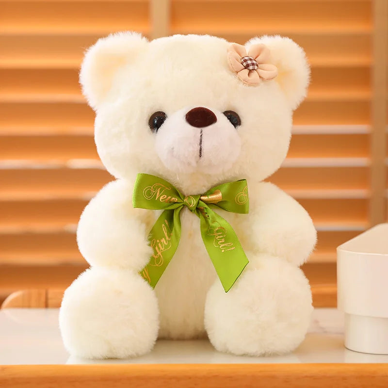 White soft plush teddy bear sitting on a wooden surface