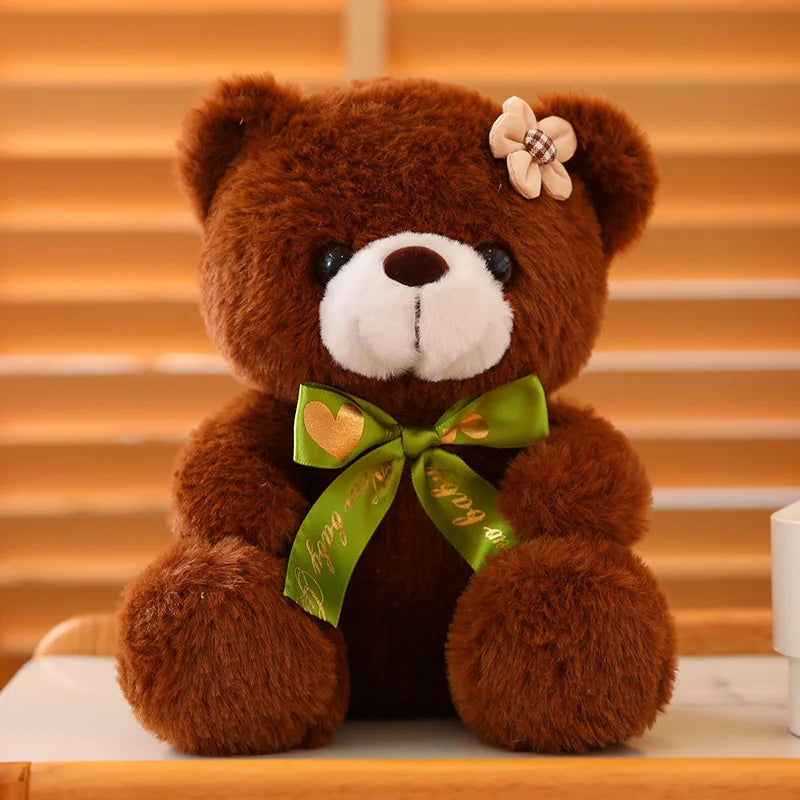 Dark brown soft plush teddy bear sitting on a wooden surface