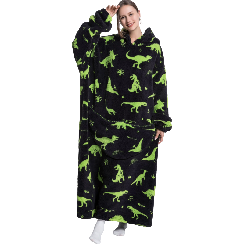 Person wearing a black hoodie with green dinosaur prints on a white background