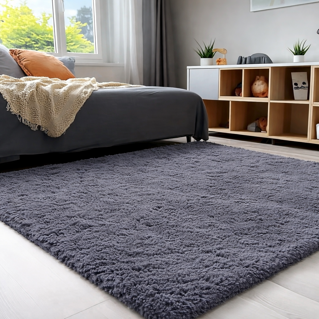 Grey shaggy rug in a living room with a bed and bookshelf.