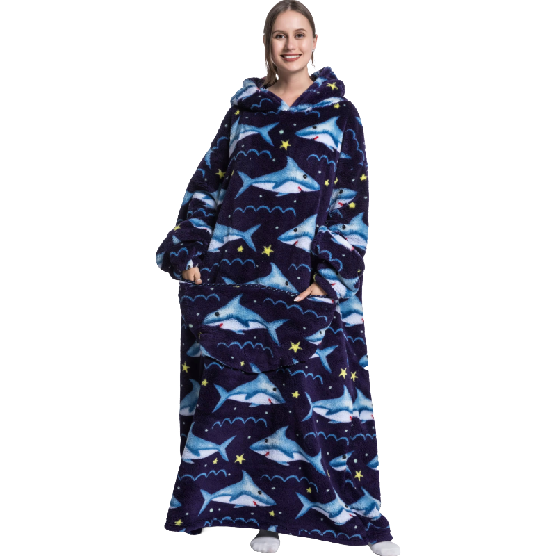 Person wearing a shark-patterned hoodie and blanket on a white background