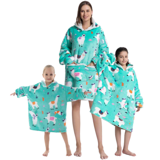 Adult and two children wearing green alpaca oversized wearable hoodies