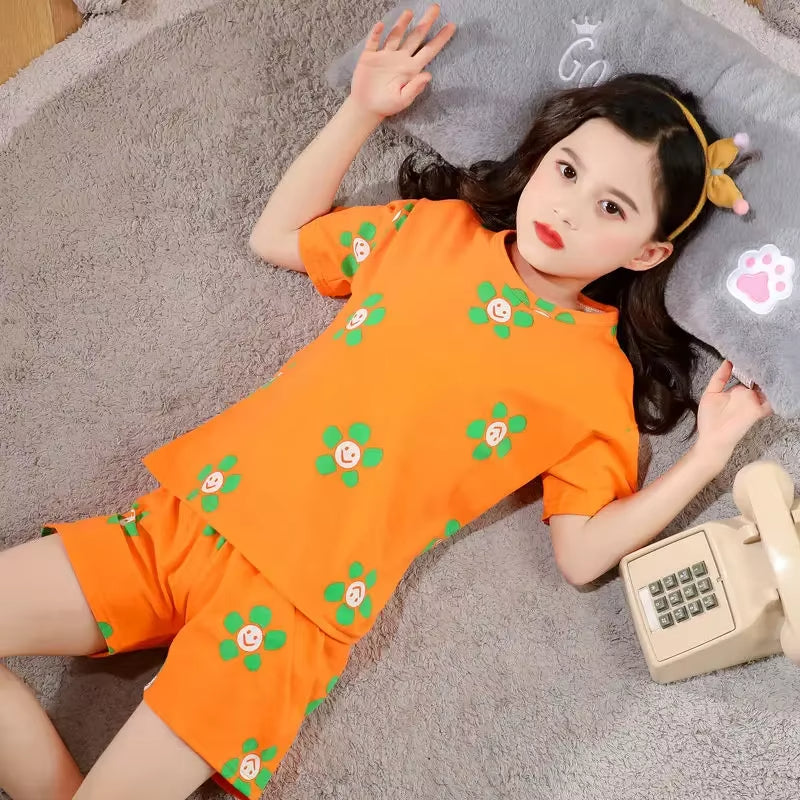 Girls cotton two-piece pyjama set with smiley flower print, short sleeve top and matching shorts