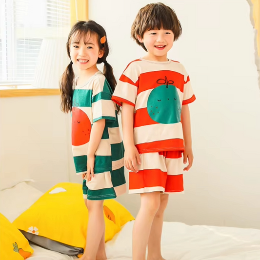 Kids wearing a cotton two-piece pyjama set with bold stripe design and fruit graphic, short sleeve top and matching shorts