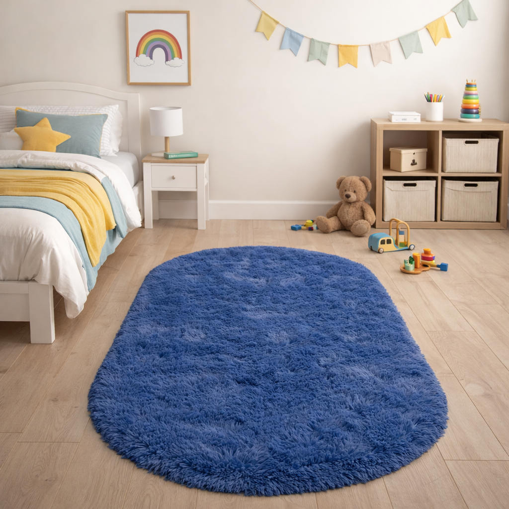 Deep blue silky plush oval rug placed on a wooden floor in a cosy children's bedroom
