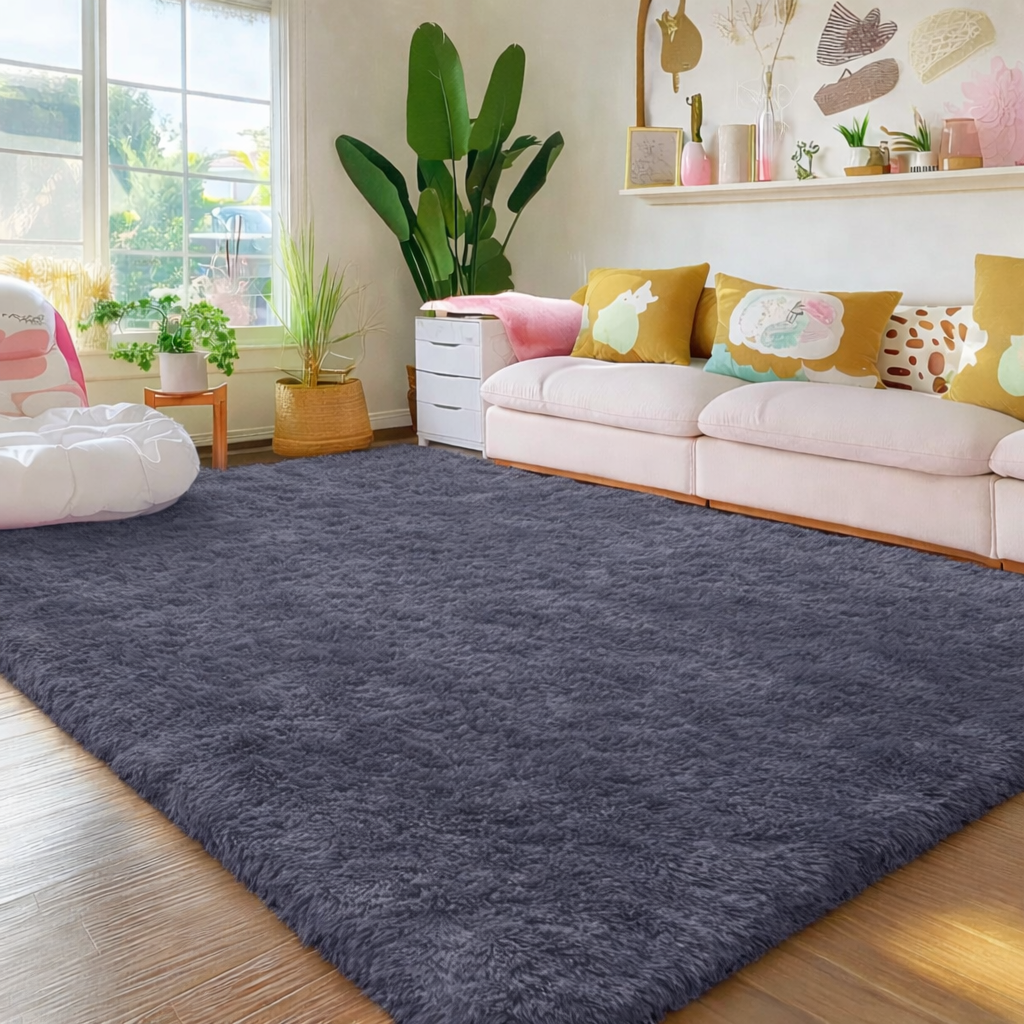 Living room with a dark gray rug, white sofa, and decorative pillows.