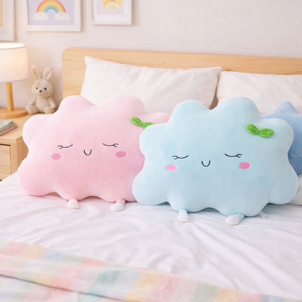 Two cloud-shaped cushions with faces on a bed