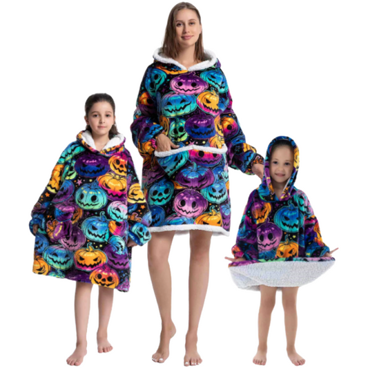 Adult and children wearing colourful oversized wearable hoodies with jack-o-lantern print and soft sherpa lining