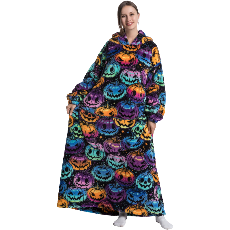 Person wearing a colorful Halloween-themed hoodie blanket with pumpkins.